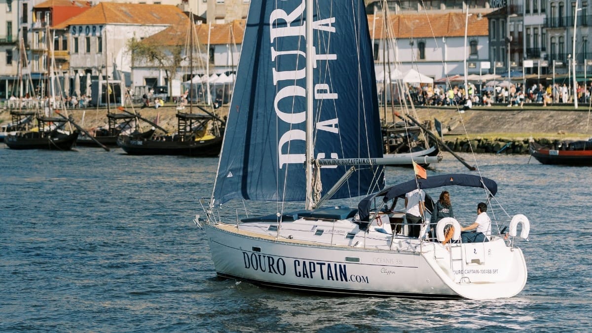 Close-up of a sailing boat with the skipper and guests enjoying the Douro River in Porto