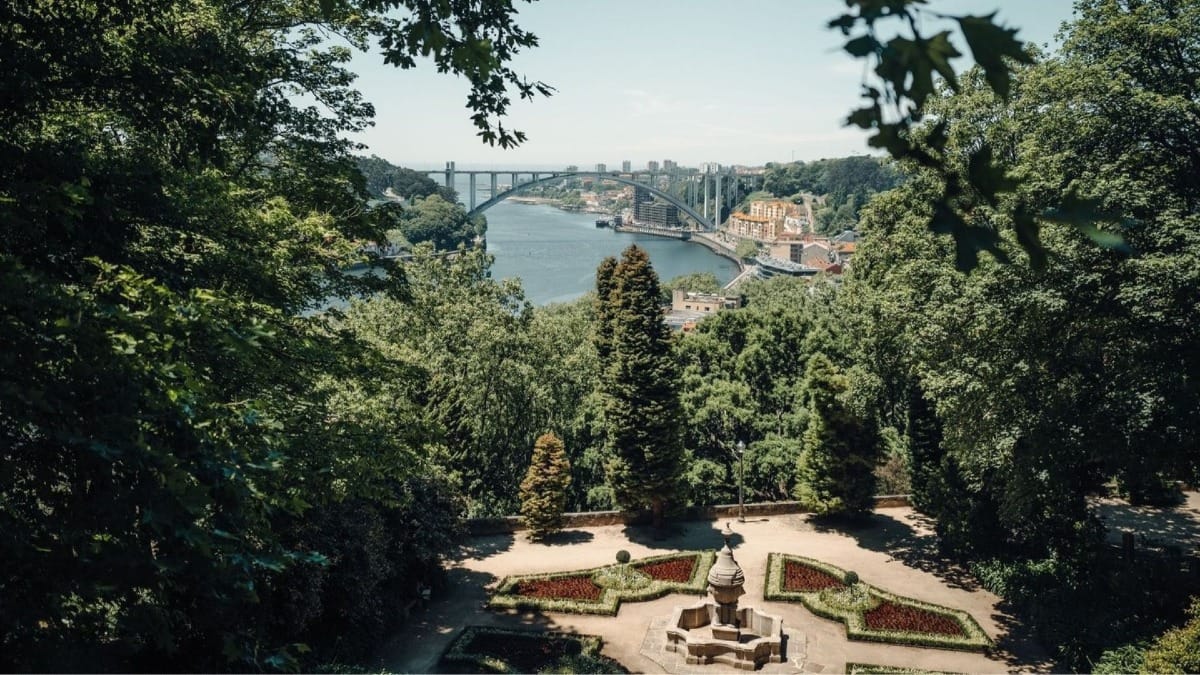 Panoramic view from Palácio de Cristal gardens over the Douro River, Arrábida Bridge, and the Atlantic Ocean in Porto