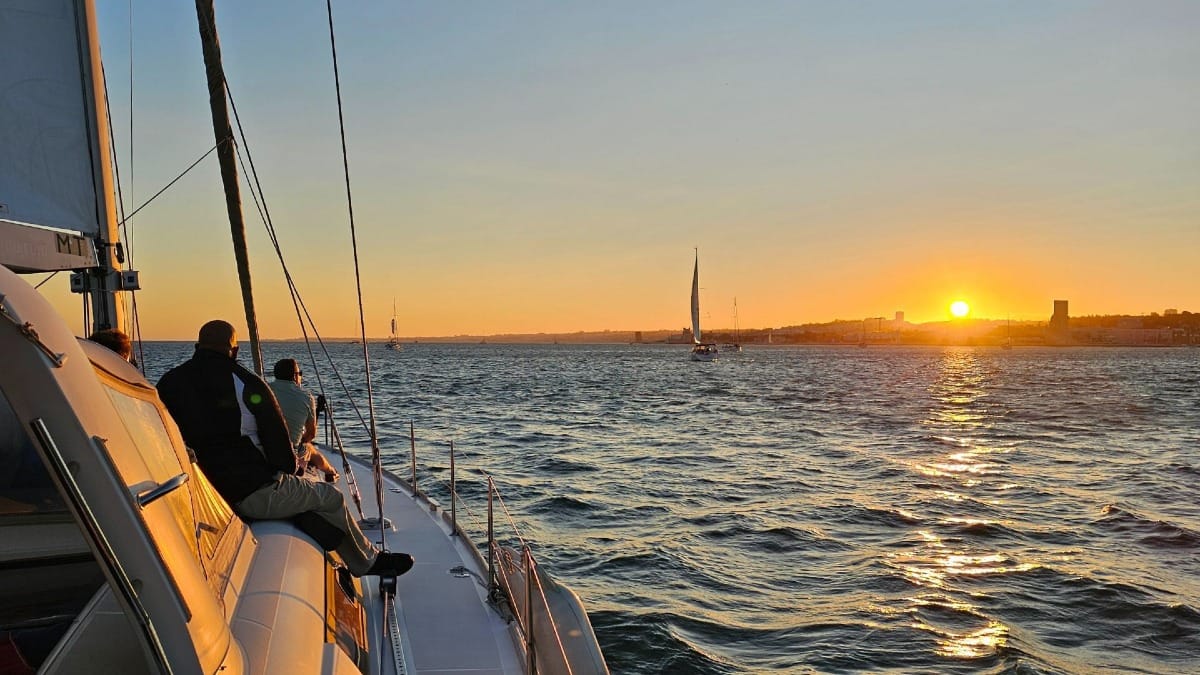 U7sH sunset over belem lisbon boat tour