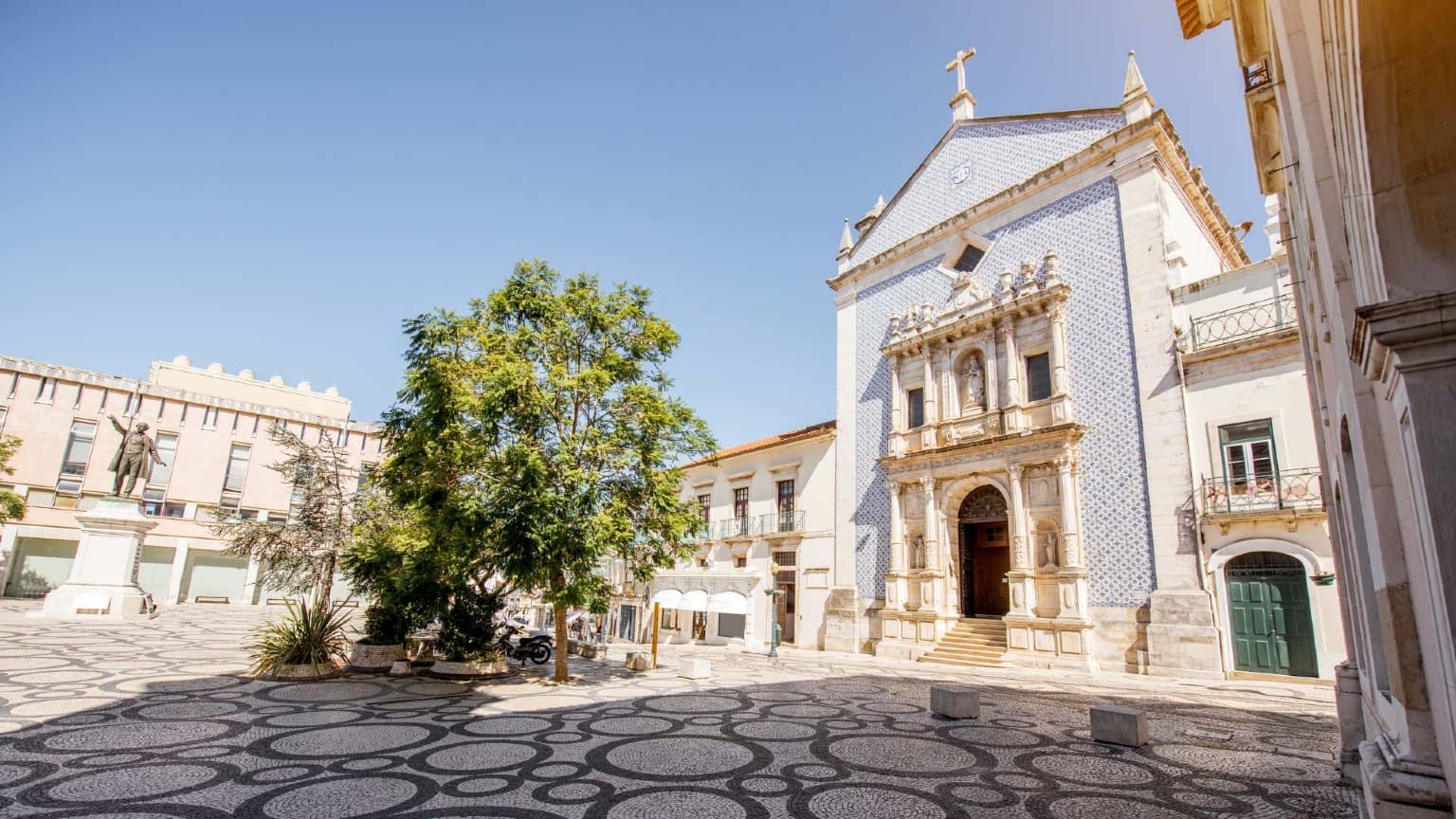 Praça da República in Aveiro with its patterned stone pavement and the tiled Misericórdia Church