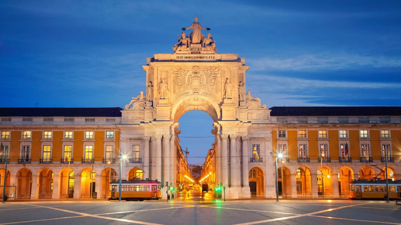 Praça do Comércio in Lisbon illuminated at dusk, one of the main celebration spots for New Year’s Eve in Portugal
