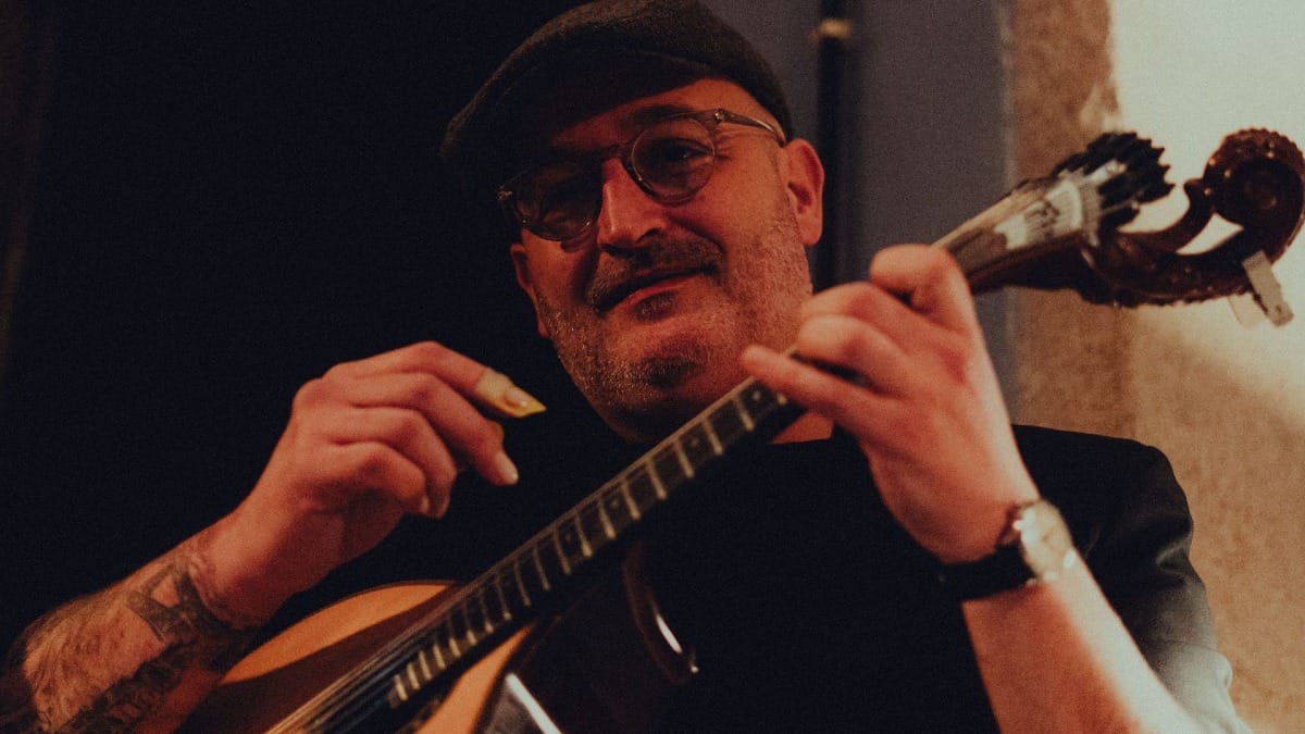 Portuguese guitar player performing live traditional Fado music in Porto