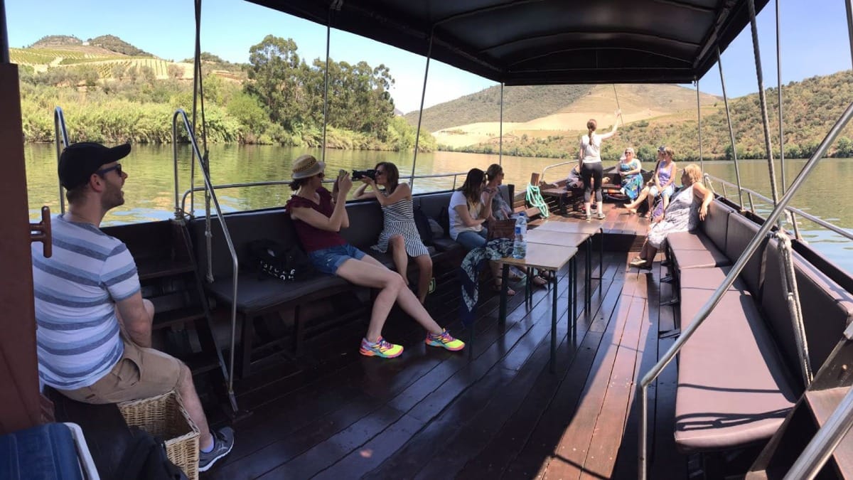 Traditional Rabelo boat cruise along the Douro River during a guided Douro Valley Wine Tour from Porto with Cooltour Oporto