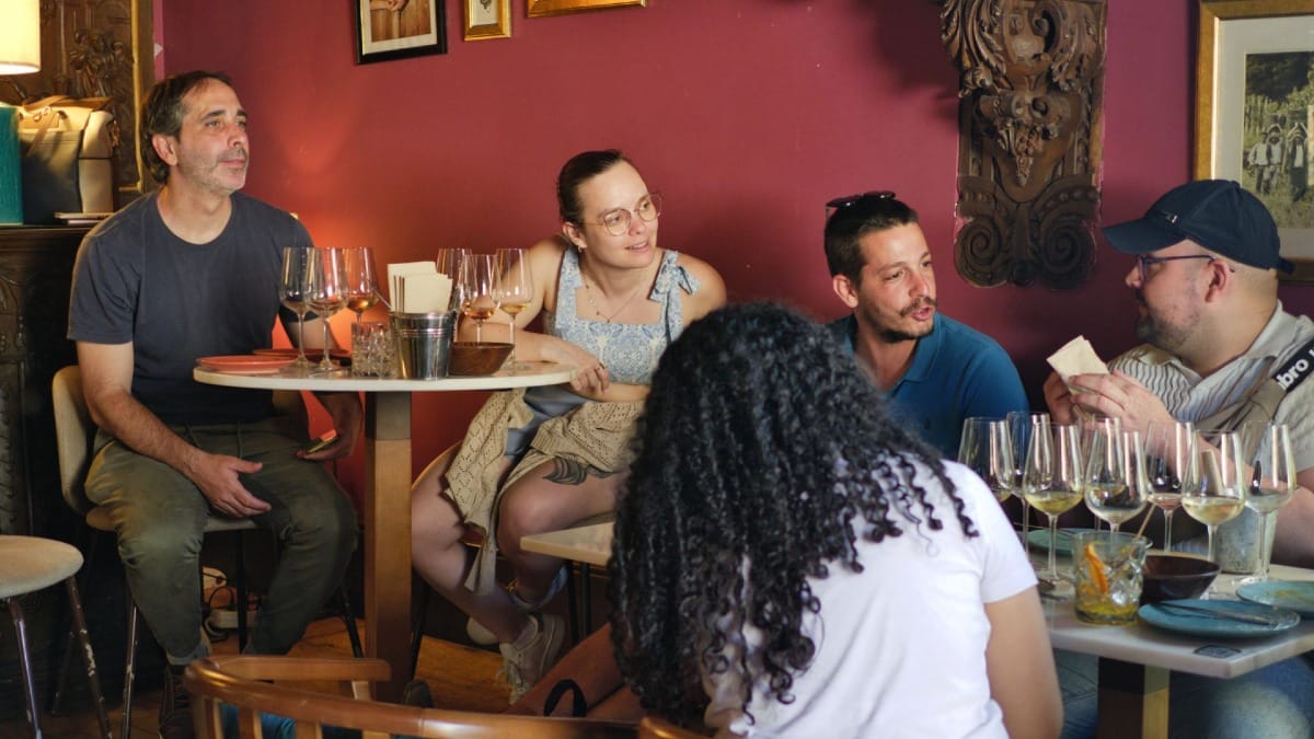 Guests enjoying guided conversation and wine tasting in an intimate wine bar in Porto