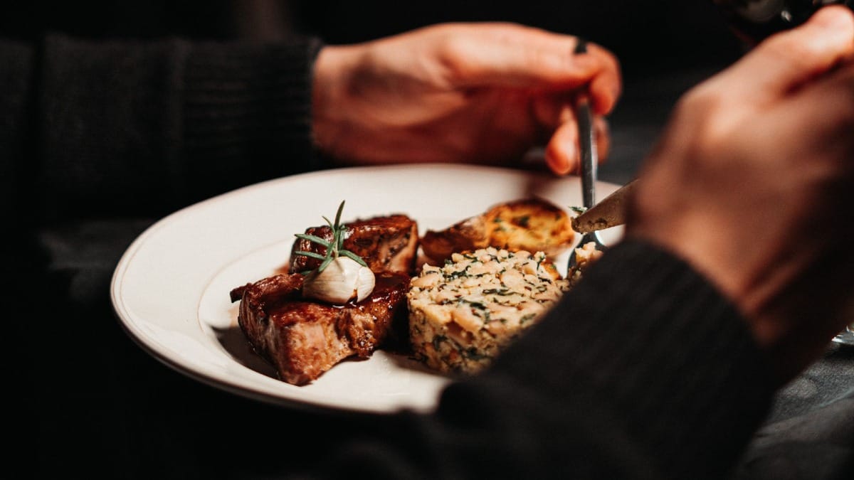 Guest enjoying a traditional Portuguese dish while listening to live Fado music in Porto