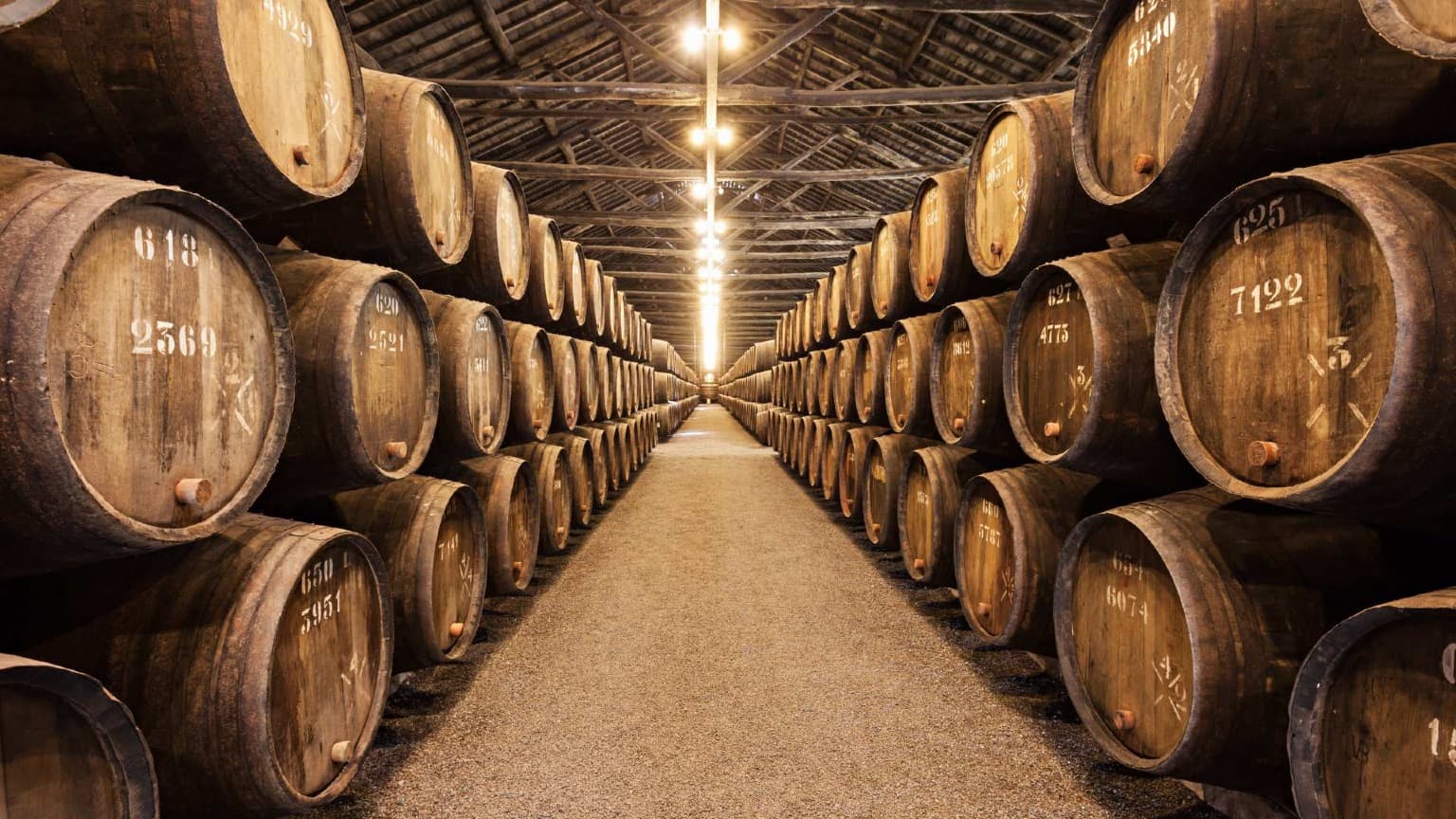 Traditional Port wine barrels inside historic wine cellars in Vila Nova de Gaia