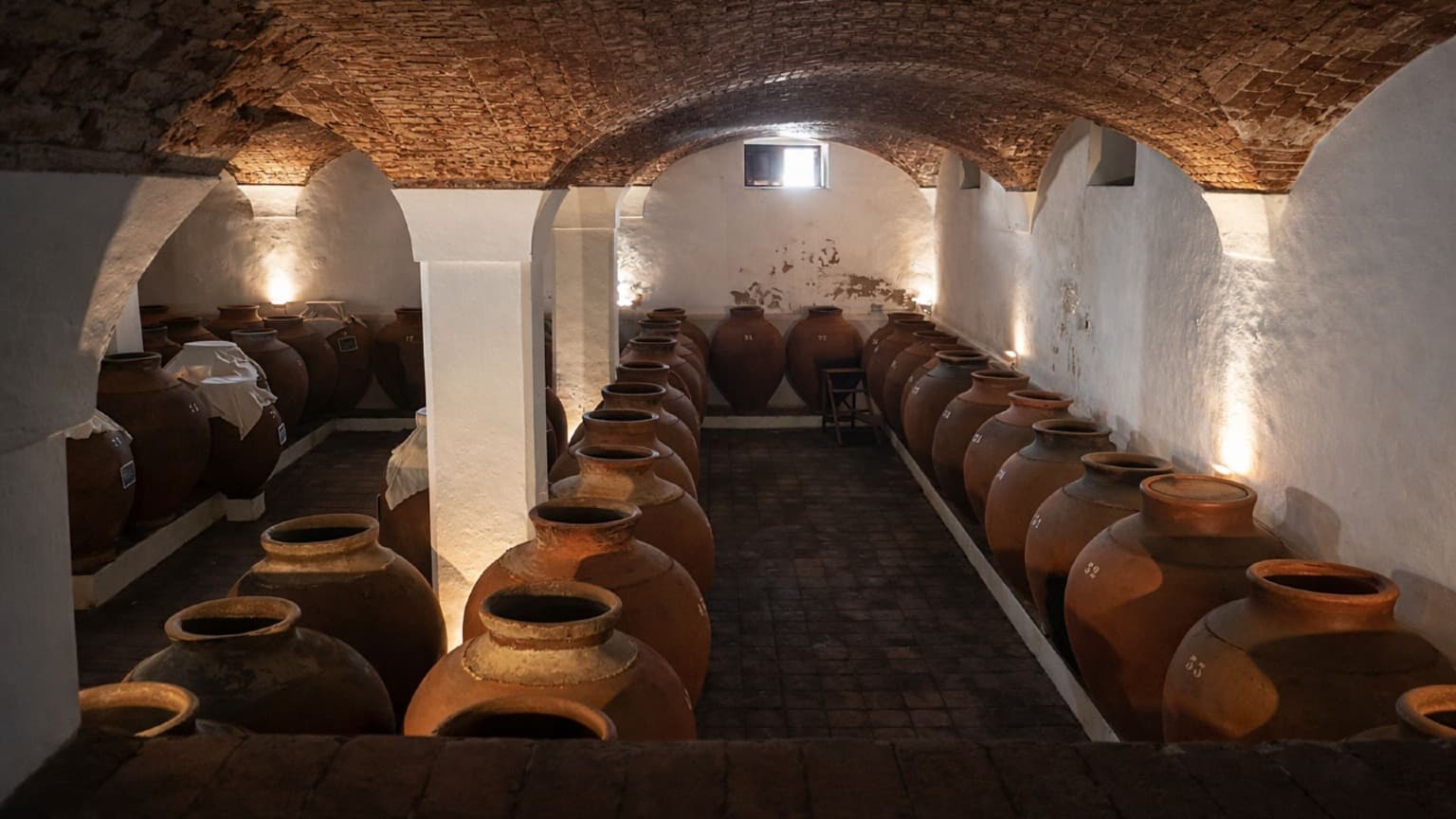 Clay amphorae used for vinho de talha in a traditional Baixo Alentejo wine cellar