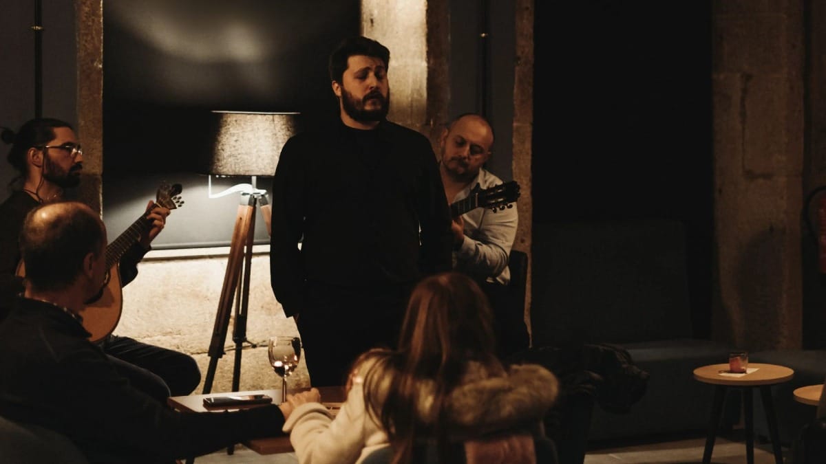Traditional Fado music concert in Porto with seated audience and candle-lit atmosphere by Cooltour Oporto